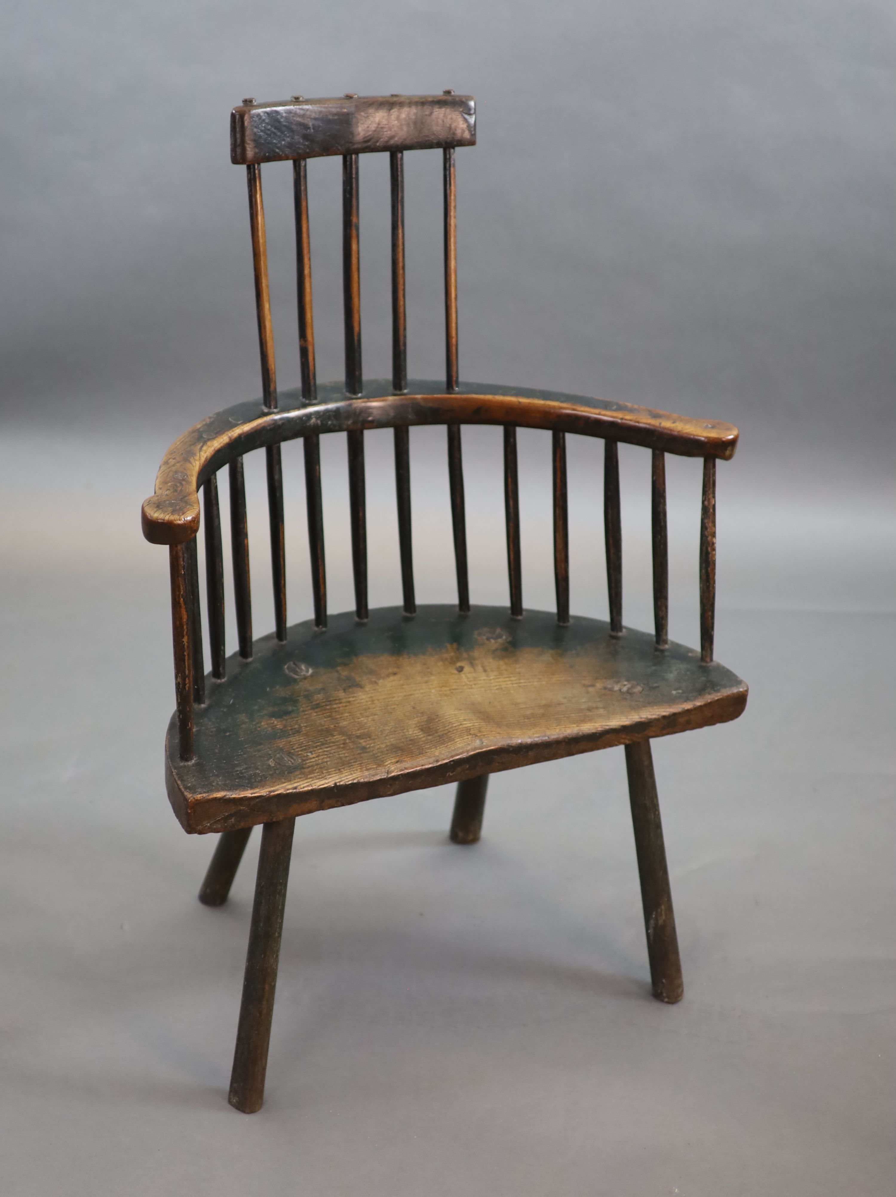 An 18th century primitive vernacular comb-back elbow chair, possibly Welsh, 70cm wide, 34cm deep, 99cm high.